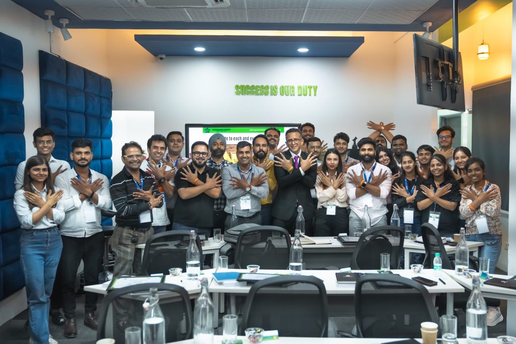 Sales training programs group posing for a photo in front of a10x boot camp with Gaurav Bhagat.
